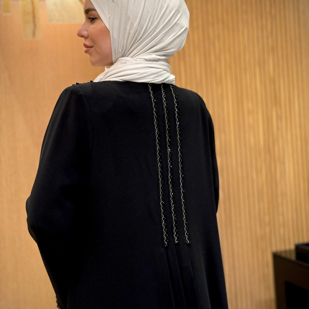 
                      
                        An elegant black abaya with beads
                      
                    