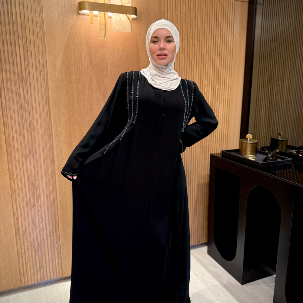 
                      
                        An elegant black abaya with beads
                      
                    